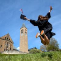 new graduate jumping in the air